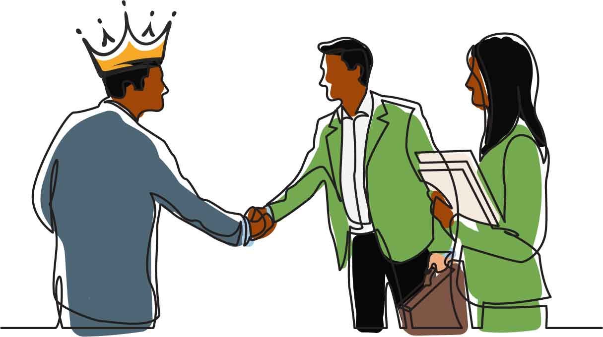 A customer wearing a crown shakes hands with two JTL staff
